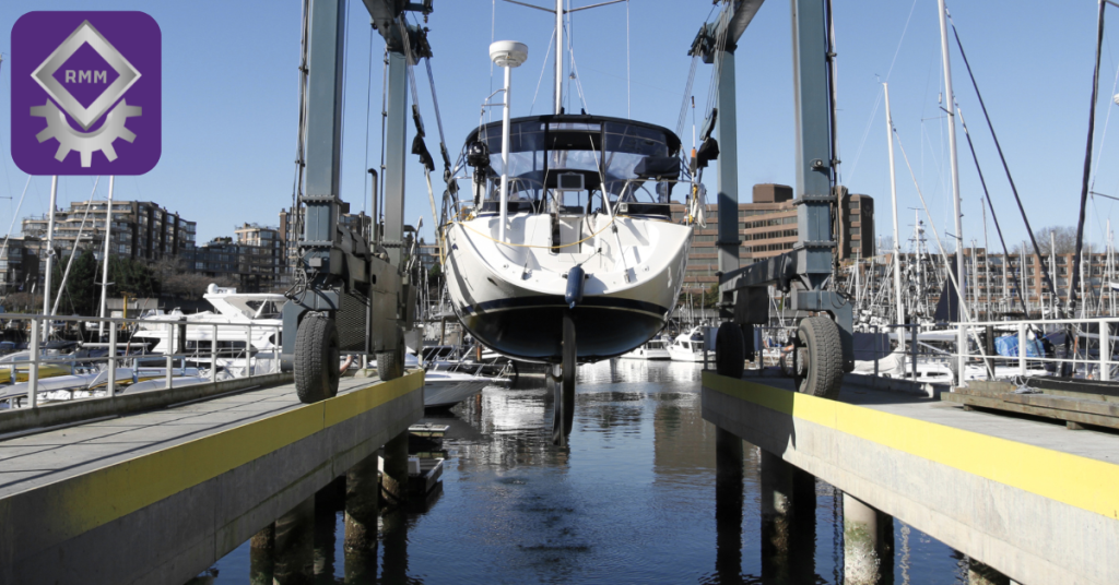 Boat stacked on modular marina rack system with hoist frames